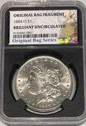 1884 O Brilliant Uncirculated Morgan $ NGC With Original Bag Fragment