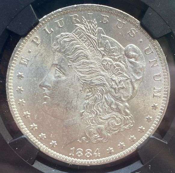 1884 O Brilliant Uncirculated Morgan $ NGC With Original Bag Fragment.