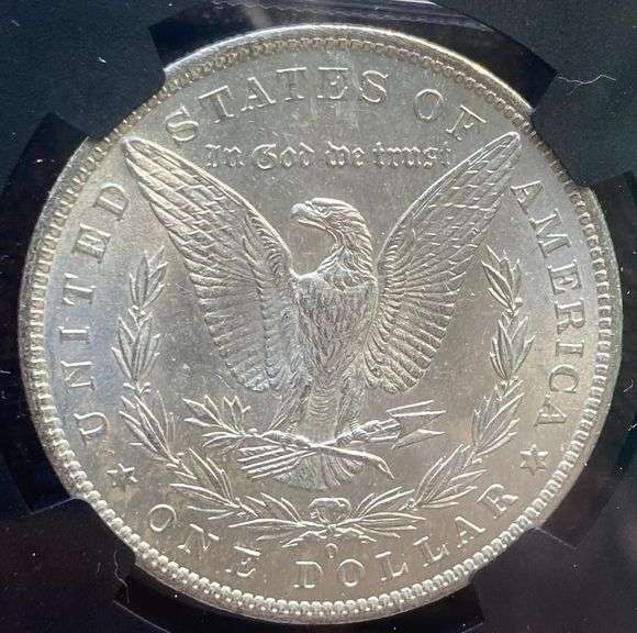 1884 O Brilliant Uncirculated Morgan $ NGC With Original Bag Fragment.