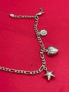 14K WHITE GOLD CHARM BRACELET.