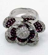 Hand made Italian 18kt white gold diamond and natural ruby articulated flower ring