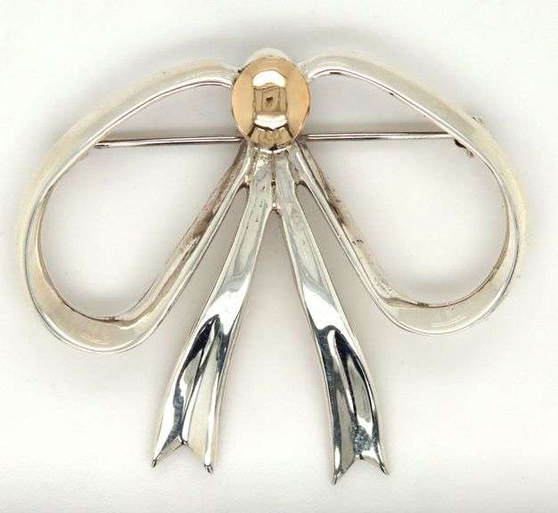 Sterling silver and 14kt Yellow gold accent bow brooch
