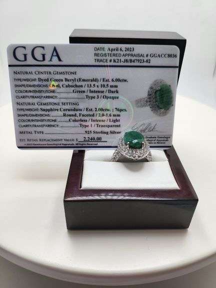 very nice dyed green beryl emerald ring. Over 6 ctw with round sapphire corundumset in silver