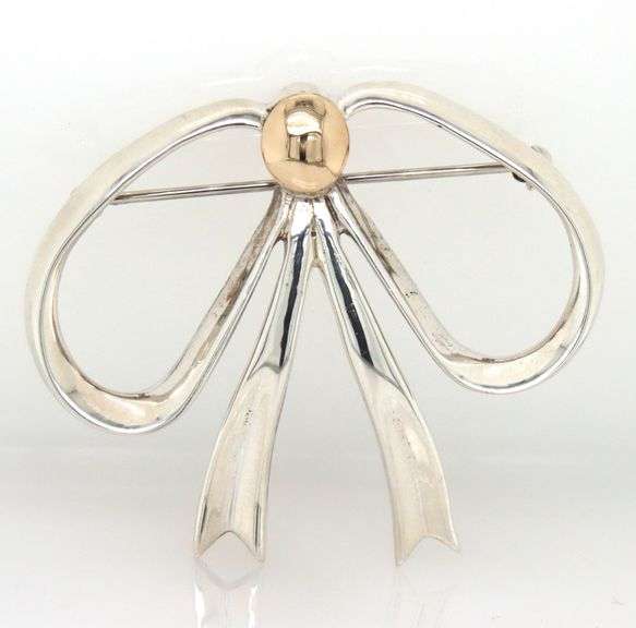 Sterling silver and 14kt Yellow gold accent bow brooch