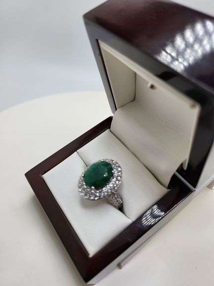 very nice dyed green beryl emerald ring. Over 6 ctw with round sapphire corundumset in silver