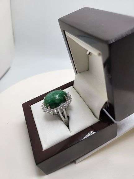 very nice dyed green beryl emerald ring. Over 13 ctw with round sapphire corundumset in silver