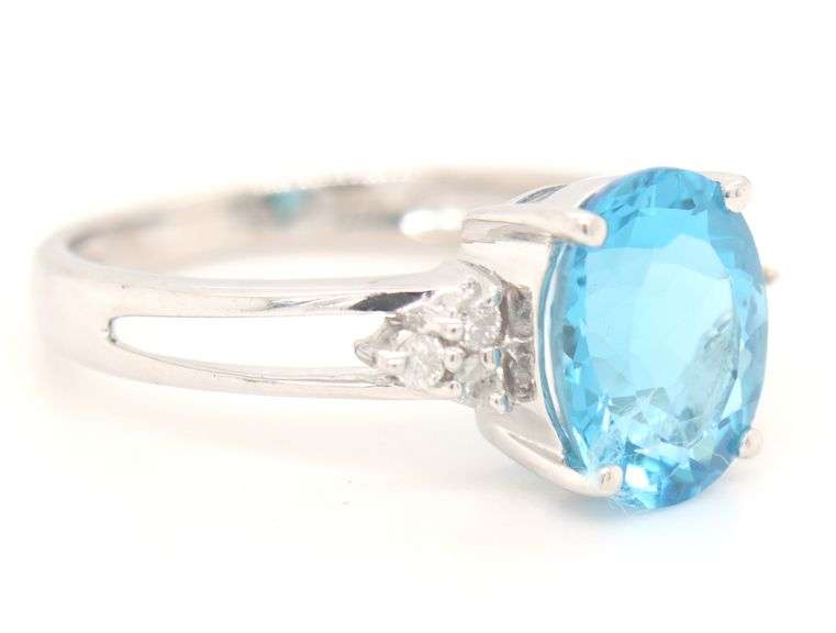 14kt White gold oval blue topaz and diamond open shank ring