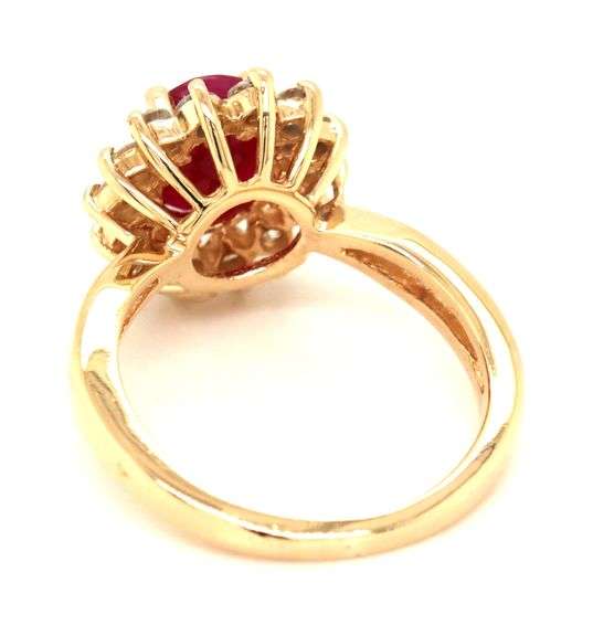 14kt Yellow gold oval lead treated ruby and diamond halo ring