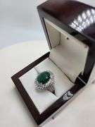 very nice dyed green beryl emerald ring. Over 6 ctw with round sapphire corundumset in silver
