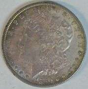 Gorgeous essentially Gem BU 1880-O Morgan Silver Dollar. Original rainbow toned