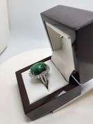 very nice dyed green beryl emerald ring. Over 13 ctw with round sapphire corundumset in silver