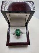 very nice dyed green beryl emerald ring. Over 13 ctw with round sapphire corundumset in silver