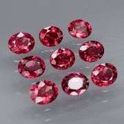 Lovely 6.08ct oval cut cherry red Rhodolite Garnet set