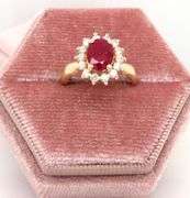 14kt Yellow gold oval lead treated ruby and diamond halo ring