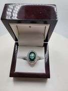 very nice dyed green beryl emerald ring. Over 6 ctw with round sapphire corundumset in silver