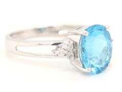 14kt White gold oval blue topaz and diamond open shank ring