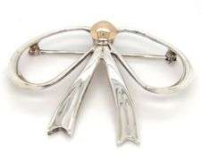Sterling silver and 14kt Yellow gold accent bow brooch