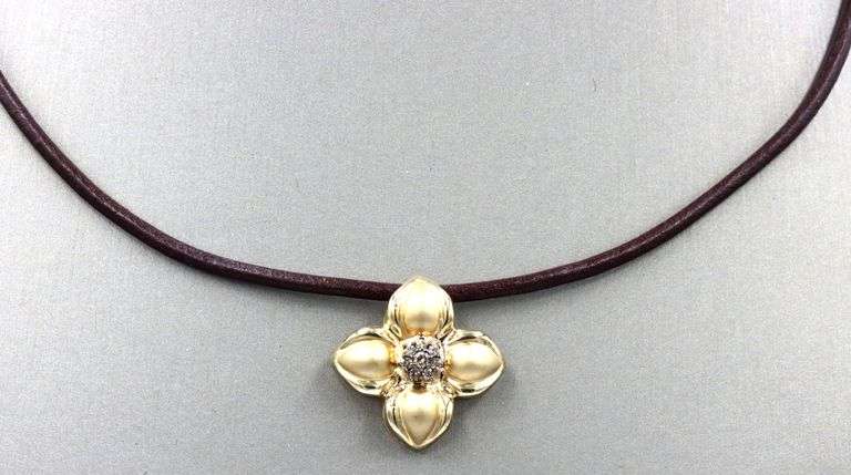 14kt Yellow gold diamond flower pendant on brown leather cord