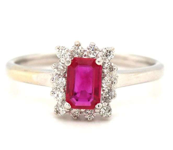 14kt White gold 0.70ct emerald cut ruby and diamond halo ring