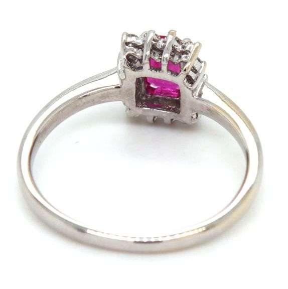 14kt White gold 0.70ct emerald cut ruby and diamond halo ring
