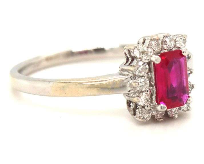 14kt White gold 0.70ct emerald cut ruby and diamond halo ring