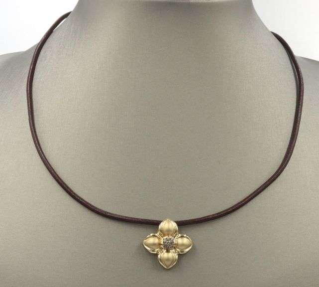 14kt Yellow gold diamond flower pendant on brown leather cord