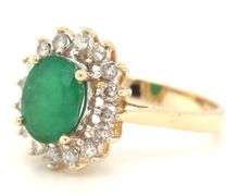 14kt Yellow gold oval emerald and diamond halo ring