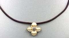 14kt Yellow gold diamond flower pendant on brown leather cord