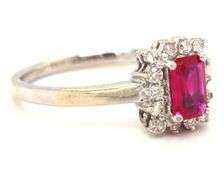 14kt White gold 0.70ct emerald cut ruby and diamond halo ring