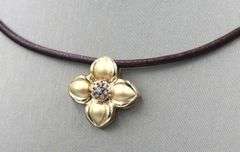14kt Yellow gold diamond flower pendant on brown leather cord