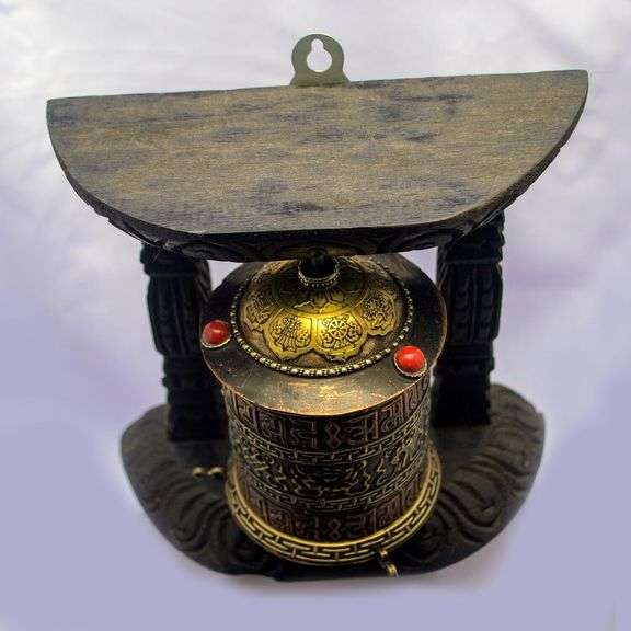Traditional Tibetan Prayer Wheel on Wooden Stand