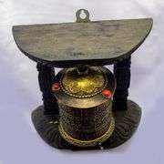 Traditional Tibetan Prayer Wheel on Wooden Stand