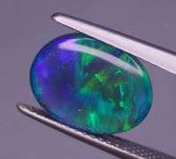 Magnificent 2.48ct full body flashing Semi Black Opal