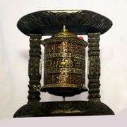 Traditional Tibetan Prayer Wheel on Wooden Stand