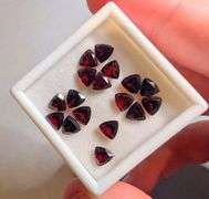 Stunning wine red 9.51ct trillion cut untreated Garnet set