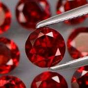 Outstanding 6.45ct diamond cut VS grade high fire Mozambique Garnet set