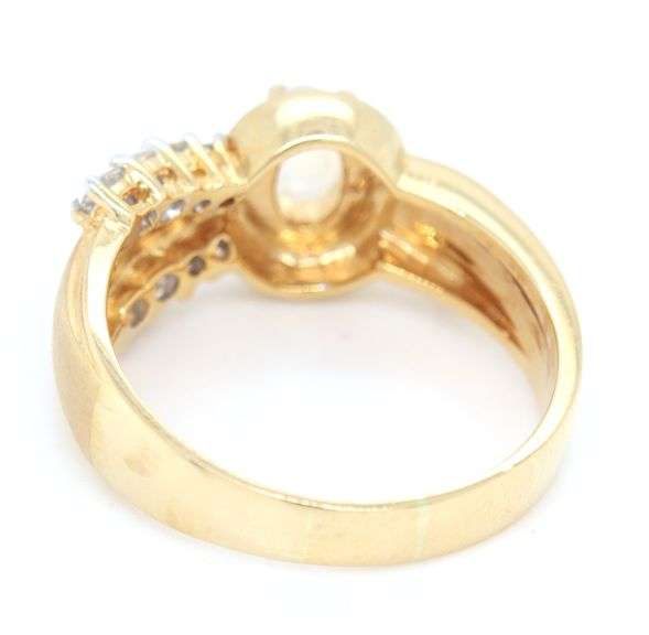 18kt Yellow gold oval moon stone and bezel diamond charm ring