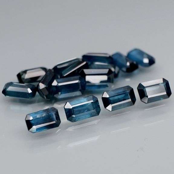 Deep blue 4.92ct emerald cut Sapphire set