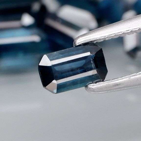 Deep blue 4.92ct emerald cut Sapphire set