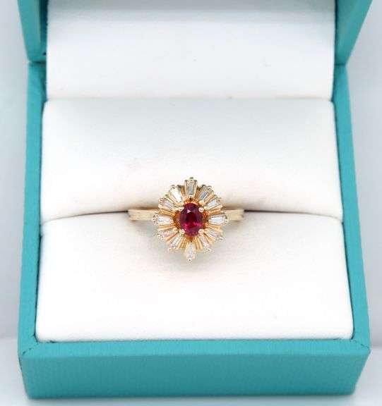 14kt Yellow gold oval ruby and baguette diamond halo ring