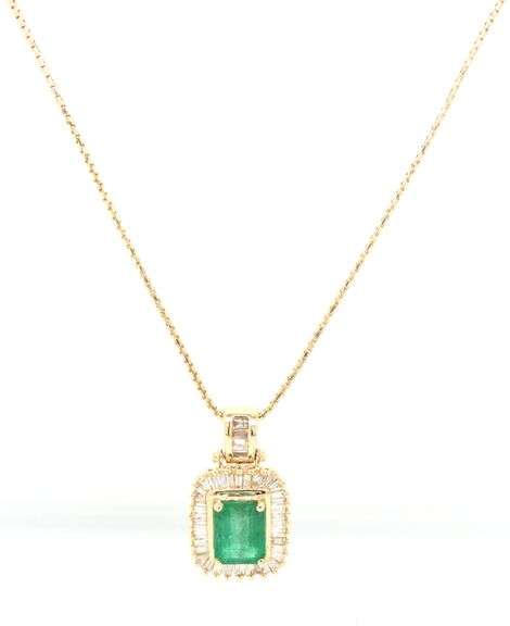 14kt Yellow gold emerald cut emerald in diamond halo pendant on chain