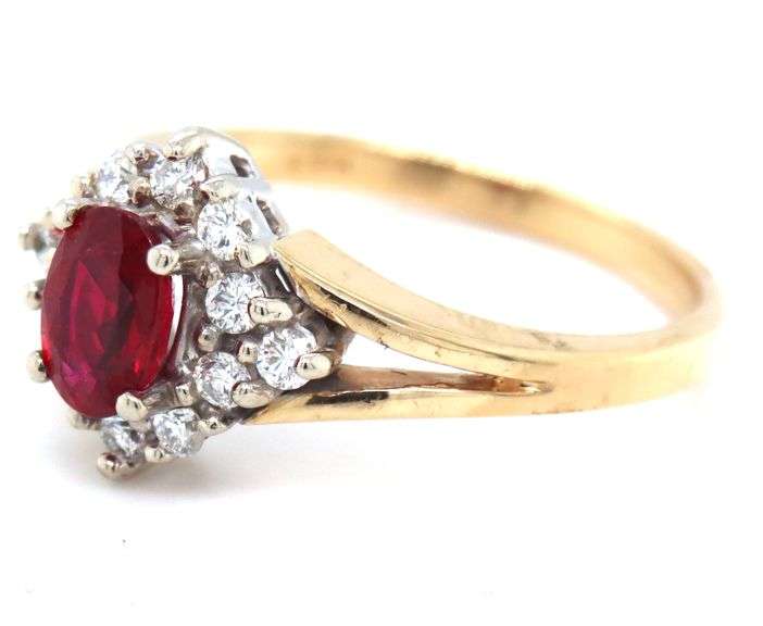 14kt Yellow gold 0.60ct oval ruby and 0.25ctw diamond halo ring