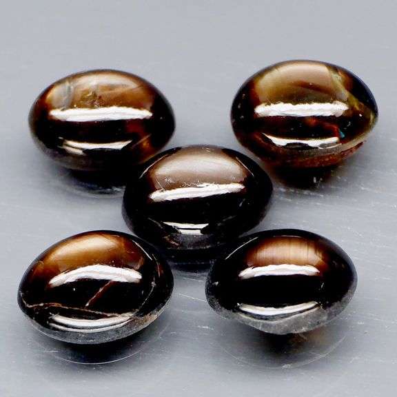 Natural 7.15ct set of golden black Star Sapphires