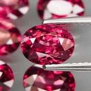 Amazing 8.96ct oval cut violet red Garnet set