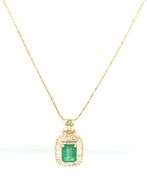 14kt Yellow gold emerald cut emerald in diamond halo pendant on chain