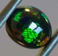 Block flashing 1.87ct black Opal cabochon