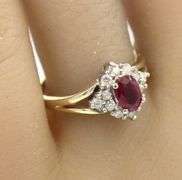 14kt Yellow gold 0.60ct oval ruby and 0.25ctw diamond halo ring