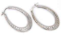 14kt White gold Textured and high polish oval hoop