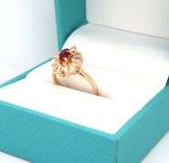 14kt Yellow gold oval ruby and baguette diamond halo ring