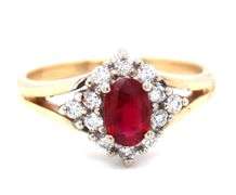 14kt Yellow gold 0.60ct oval ruby and 0.25ctw diamond halo ring
